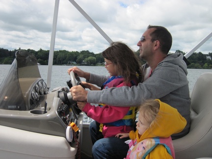 Joe and his kids driving the boat